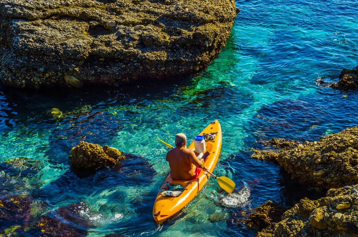 Senior kayaker on a kayak by the sea, active water sport and leisure, kayaking